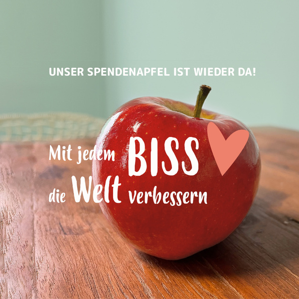 KI generiert: Das Bild zeigt einen roten Apfel mit der Aufschrift "Mit jedem Biss die Welt verbessern" und einem Herzsymbol. Darüber steht "Unser Spendenapfel ist wieder da!".