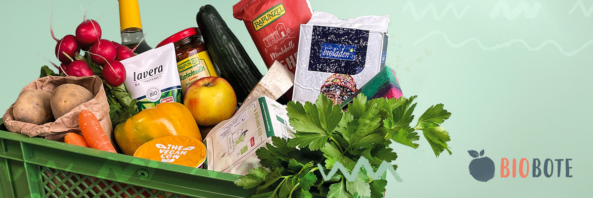 KI generiert: Das Bild zeigt eine grüne Kiste voller verschiedener Lebensmittel, darunter frisches Gemüse, verpackte Produkte und Kräuter. Auf der rechten Seite befindet sich das Logo "BIOBOTE".